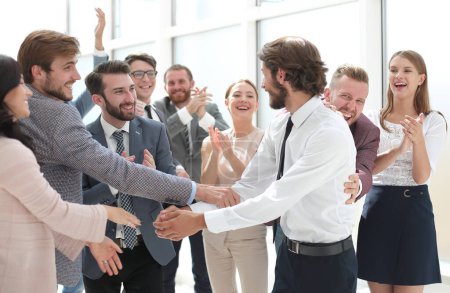 Photo for Business team congratulating their leader on the victory - Royalty Free Image