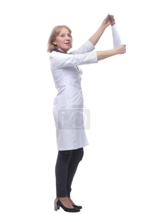 Photo for \Side view of female doctor looking at x-ray"\ - Royalty Free Image