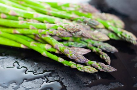 Photo for Green asparagus is very useful for girls and athletes. - Royalty Free Image