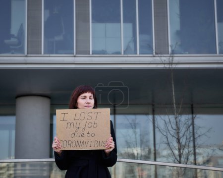 Foto de La mujer sostiene un cartel diciendo que perdí mi trabajo por el coronavirus. - Imagen libre de derechos
