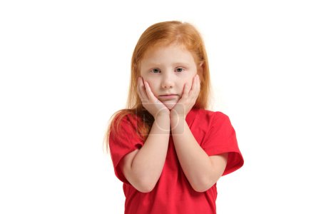 Téléchargez les photos : Portrait of sad grey-eyed little girl with hands near her face isolated on white background - en image libre de droit