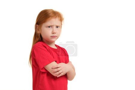 Photo for Cute little girl with red hair and folded arms looking angry isolated white background - Royalty Free Image