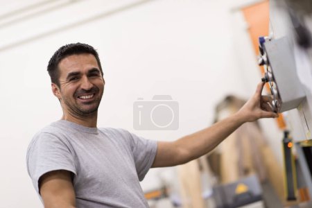Photo for Male worker in a factory of wooden furniture - Royalty Free Image