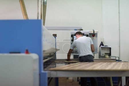 Photo for Worker in a factory of wooden furniture - Royalty Free Image
