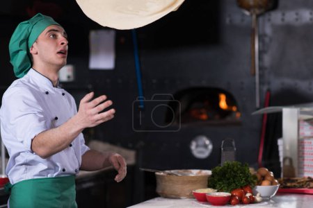 Photo for "chef throwing up pizza dough" - Royalty Free Image