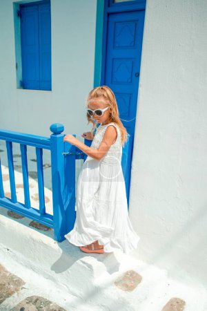 Photo for Adorable little girl at old street of typical Greek traditional village - Royalty Free Image
