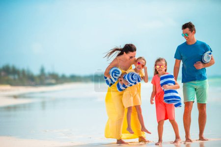 Photo for Young family of four on beach vacation - Royalty Free Image