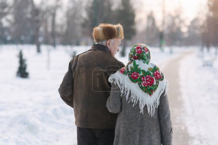 Photo for Back view of elderly couple walking in the park. Happy old people toghether though the years - Royalty Free Image