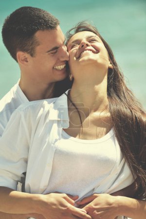 Téléchargez les photos : Heureux jeune couple avoir du plaisir sur la plage - en image libre de droit