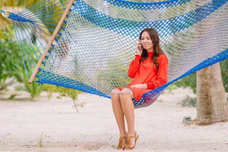 Photo for Adorable girl on tropical vacation relaxing in hammock - Royalty Free Image