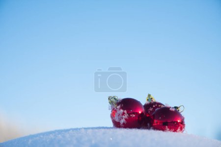 Téléchargez les photos : Boules de Noël rouges dans la neige fraîche. Vacances d'hiver conept - en image libre de droit