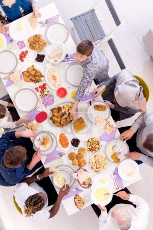 Photo for Top view of modern multiethnic muslim family having a Ramadan feast - Royalty Free Image
