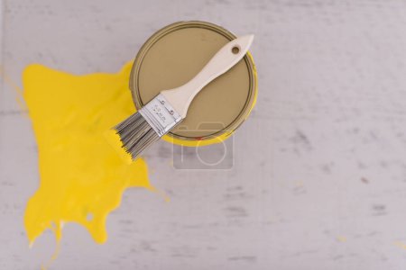 Photo for Yellow paint tin can with brush on top - Royalty Free Image