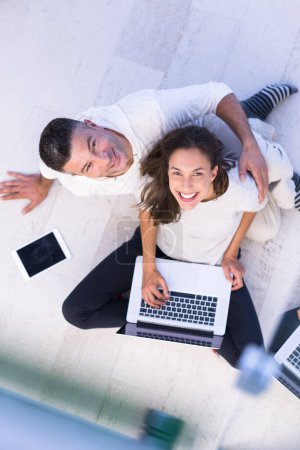 Photo for Couple using tablet and laptop computers, top view - Royalty Free Image