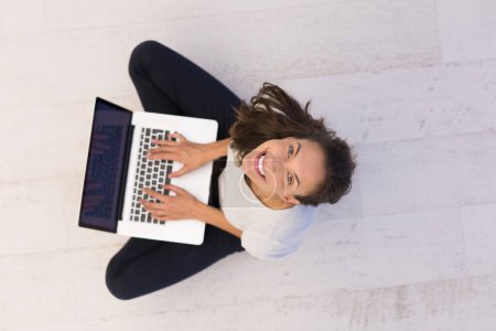 Photo for Woman using laptop computer on the floor top view - Royalty Free Image