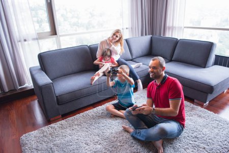 Photo for Happy family playing a video game - Royalty Free Image
