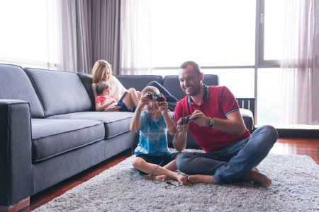 Photo for Happy family playing a video game - Royalty Free Image