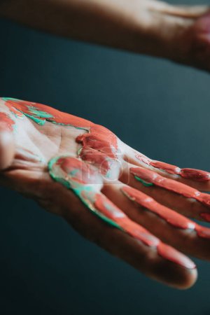Foto de Fun leisure. Creative female artist showing hands dirty with different colors paint.Dark background. Artistic creative concepts, beauty image - Imagen libre de derechos