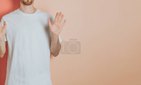 Photo for "Man standing over isolated and smiling colorful background. Young woman dressed in white t-shirt, blank space t shirt copy space, design, shopping commercial shot" - Royalty Free Image