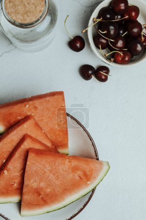 Photo for "Bunch of summer and fresh fruits over a minimalist white table, watermelon and cherry, wellness and healthy food concepts, tasty , textured, copy space" - Royalty Free Image