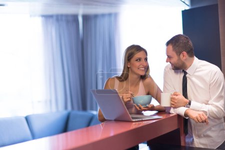 Photo for A young couple is preparing for a job and using a laptop - Royalty Free Image