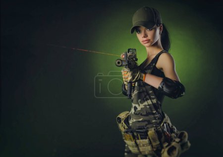 Photo for A soldier girl poses with an automatic rifle - Royalty Free Image