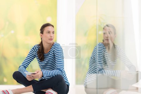 Photo for Young woman using tablet computer on the floor - Royalty Free Image