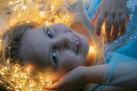 Photo for Little girl with christmas lights - Royalty Free Image