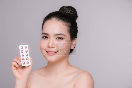 Photo for Girl is holding pack of pill with vitamins - Royalty Free Image