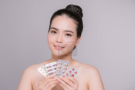 Photo for Beautiful Smiling Woman Holding Blister Packs With Pills In Hands - Royalty Free Image