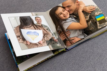 Photo for Family photos archive saved in brightly designed photo book bright summer memories placed in the photobook. family with flag of ukraine" - Royalty Free Image