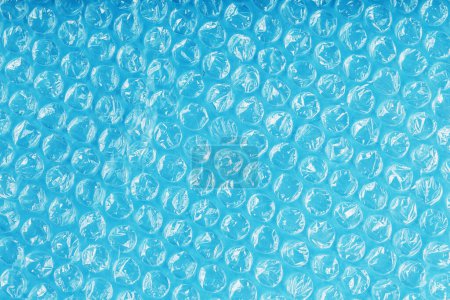 Photo for Texture of the packaging air-bubble film on a blue background in full screen - Royalty Free Image