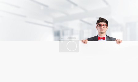 Photo for "Young businessman holds a banner" - Royalty Free Image