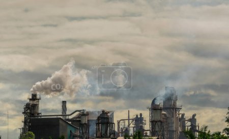 Photo for "CO2 emissions. CO2 greenhouse gas emissions from factory chimneys. Carbon dioxide gas global air climate pollution. Carbon dioxide in earths atmosphere. Greenhouse gas. Smoke emissions from chimneys." - Royalty Free Image