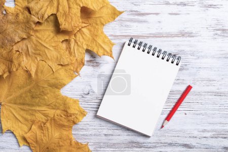 Photo for "Spiral notepad and pen lies on vintage wooden desk" - Royalty Free Image