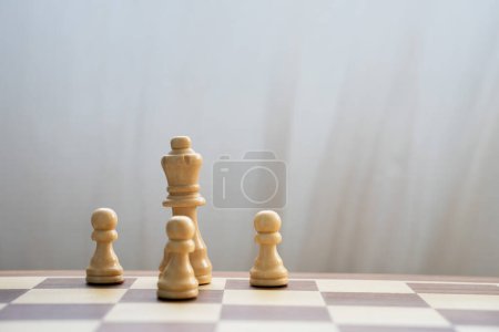 Photo for "White queen and pawns on chess board" - Royalty Free Image