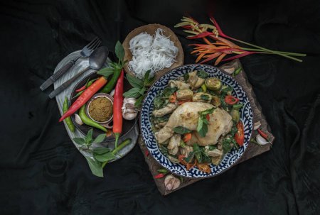 Photo for "Green curry with Chicken and Thai eggplants (Kaeng khiao wan) in Ceramic bowl served with Rice noodles." - Royalty Free Image
