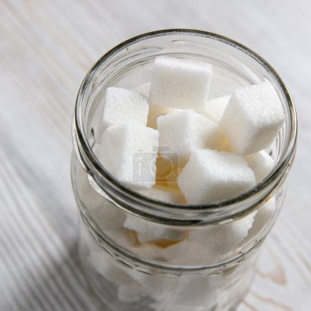 Photo for Glass jar with refined sugar in pieces - Royalty Free Image
