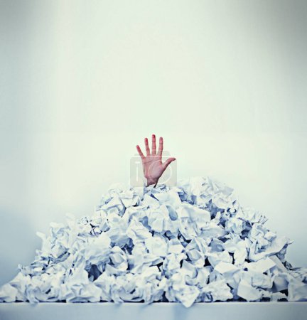 Photo for Help I'm drowning in paperwork. Cropped shot of a businessman buried under a pile of crumpled up paperwork. - Royalty Free Image