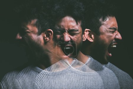 Photo for "I didnt believe in monsters until my mind created them. Studio shot of a young man experiencing mental anguish and screaming against a black background." - Royalty Free Image