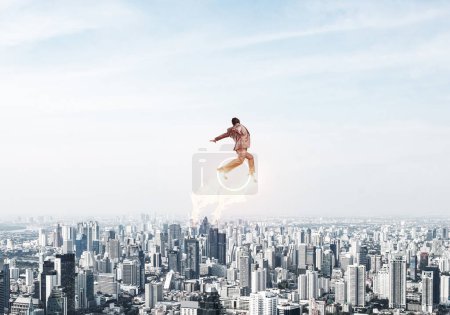 Photo for Businessman in suit and aviator hat flying in sky - Royalty Free Image
