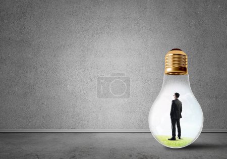 Photo for "Businessman trapped in bulb" - Royalty Free Image