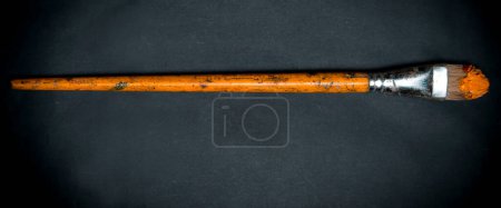Photo for "Vintage brush with oil paint on the dark background." - Royalty Free Image