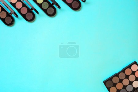Photo for "Various eyeshadows on blue background" - Royalty Free Image