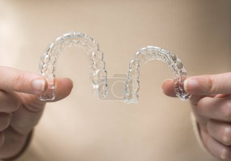 Photo for Hands holding transparent retainer - Royalty Free Image