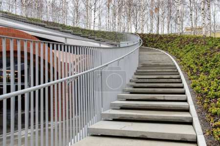 Photo for "Tall modern winding staircase with railings in a birch grove" - Royalty Free Image