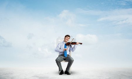 Photo for "young businessman playing violin" - Royalty Free Image