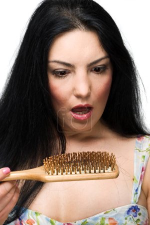 Photo for "Shocked woman loss hair on hairbrush" - Royalty Free Image