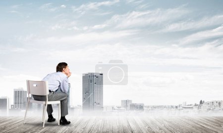 Photo for "Young businessman sitting on an office chair" - Royalty Free Image