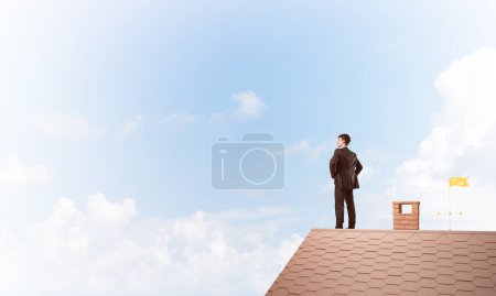 Photo for "Mister boss on brick roof with arms akimbo. Mixed media" - Royalty Free Image